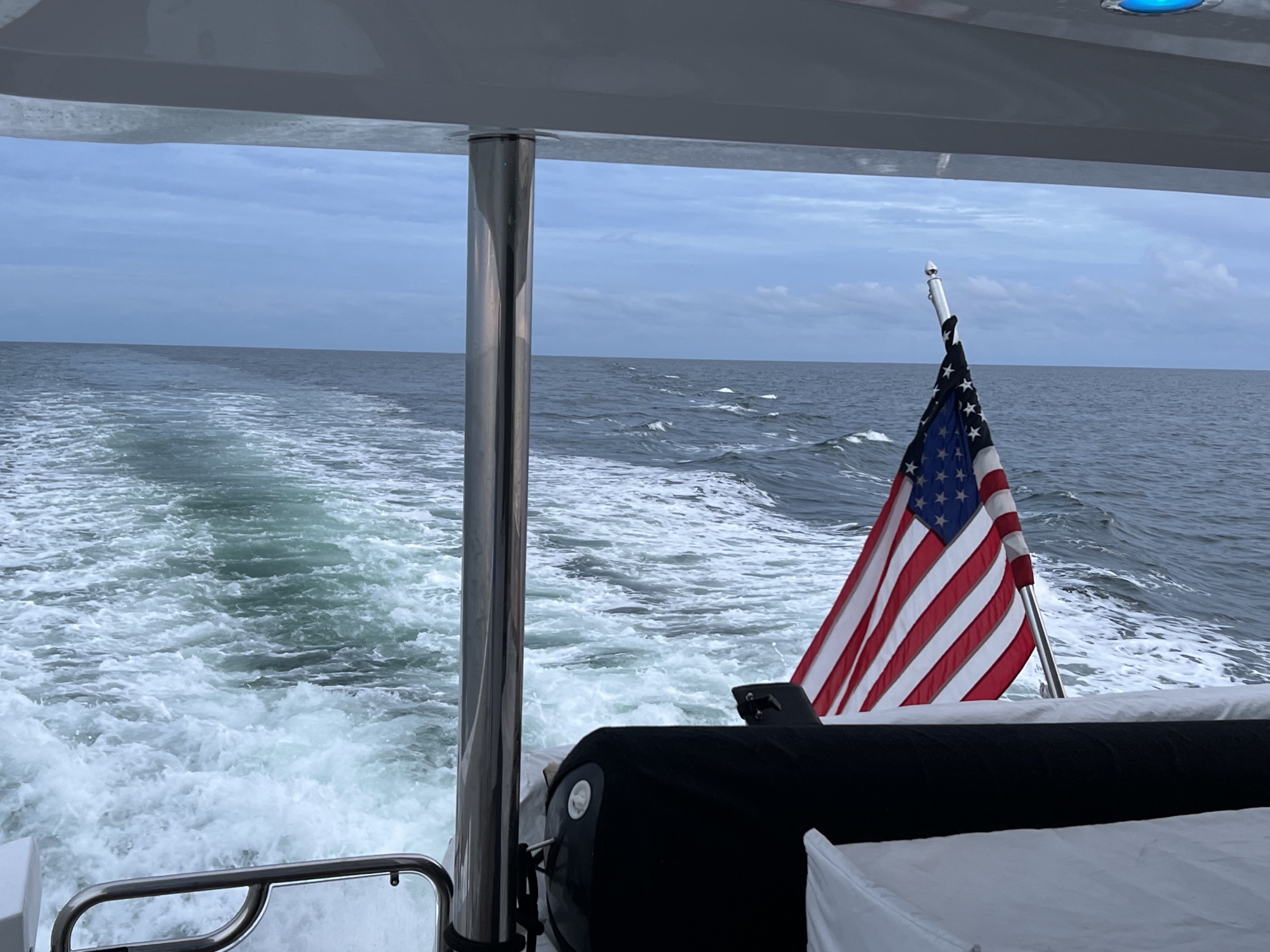 American flag over the wake of a moving boat