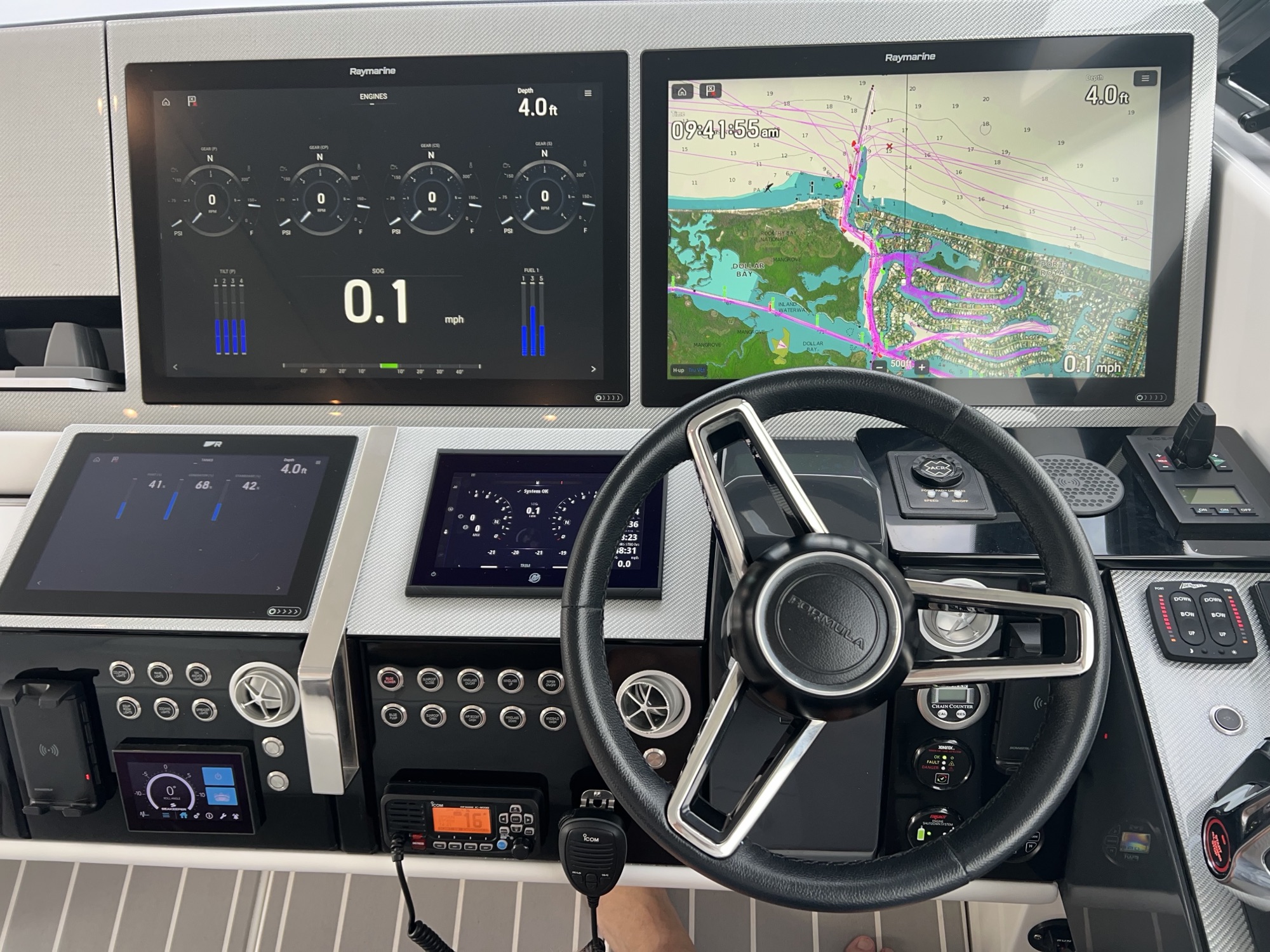 Modern helm with classic wheel and Raymarine engine and chart displays